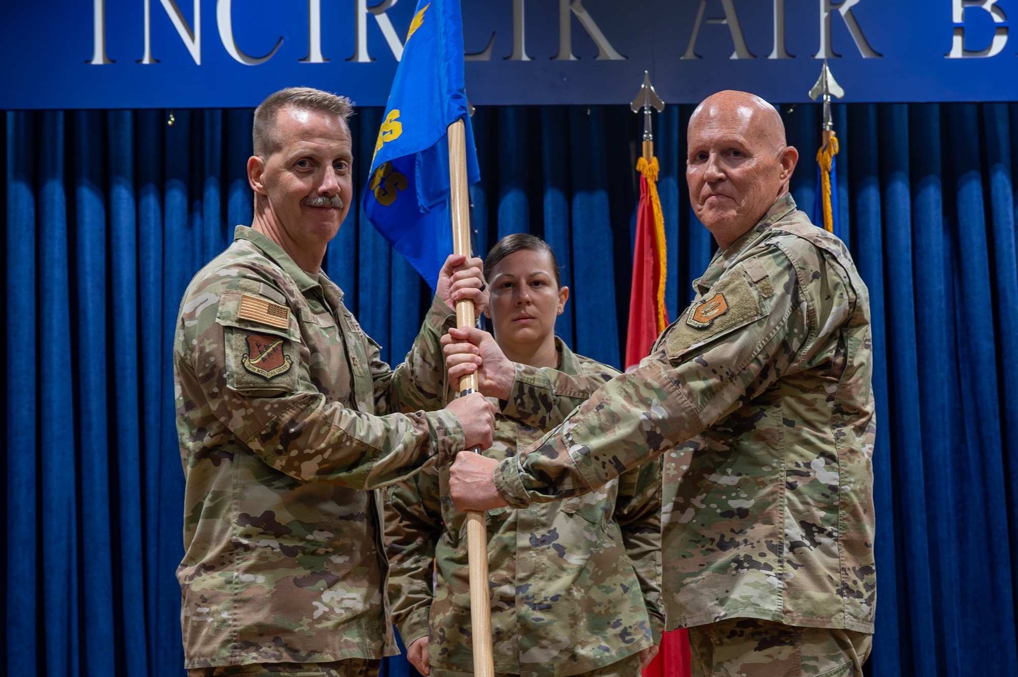 U.S. Air Force Col. Christian Smith, commander of the 39th Medical Group, takes the guidon from Lt. Col. Richard Odosso, 39th Operational Medical Readiness Squadron outgoing commander, during a change of command ceremony at Incirlik Air Base, Turkey, June 10, 2025. The change of command ceremony is a long-standing military tradition that represents the formal transfer of responsibility from one officer to another. (U.S. Air Force photo by Staff Sgt. Koby I. Saunders)
