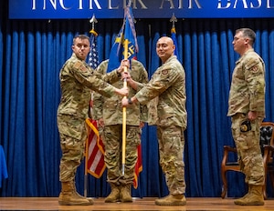 U.S. Air Force Maj. Anthony Langdon, 39th Security Forces Squadron incoming commander, receives the unit guidon from Col. John Szczepanski, 39th Weapons System Security Group commander, during the 39th SFS change of command ceremony at Incirlik Air Base, Türkiye, June 26, 2025.