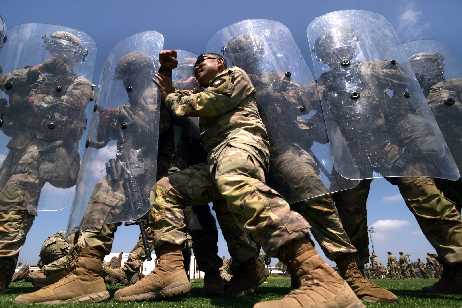 Sgt. 1st Class Andres Agag, a mortar team leader with Troop A, 1st Squadron, 18th Cavalry Regiment, California Army National Guard, pushes against the shields of other unit members while playing the role of an aggressive demonstrator during training at Joint Forces Training Base, California, on riot and crowd control techniques, June 22, 2025.