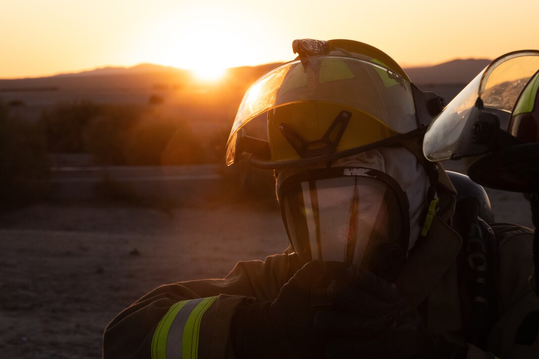 U.S. Marine Corps Lance Cpl. Yifei Zhao, a firefighter, with Aircraft Rescue and Fire Fighting, Marine Wing Support Squadron 472, 4th Marine Aircraft Wing, breathes into a gas mask during a simulated aircraft fire-fighting drill at Integrated Training Exercise 3-25, Marine Corps Air Ground Combat Center, Twentynine Palms, California, June 17, 2025. ITX is a critical Marine Air-Ground Task Force exercise for the Marine Forces Reserve’s training cycle, confirming unit readiness through live-fire and combined-arm integration. (U.S. Marine Corps photo by Lance Cpl. Edward Spears)