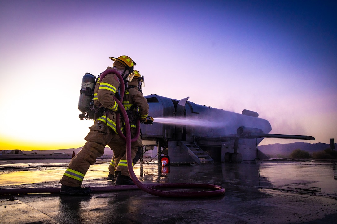 U.S. Marines with Aircraft Rescue and Fire Fighting, Marine Wing Support Squadron 472, 4th Marine Aircraft Wing, conduct a simulated aircraft fire-fighting drill at Integrated Training Exercise 3-25, Marine Corps Air Ground Combat Center, Twentynine Palms, California, June 17, 2025. ITX is a critical Marine Air-Ground Task Force exercise for the Marine Forces Reserve’s training cycle, confirming unit readiness through live-fire and combined-arm integration. (U.S. Marine Corps photo by Lance Cpl. Edward Spears)