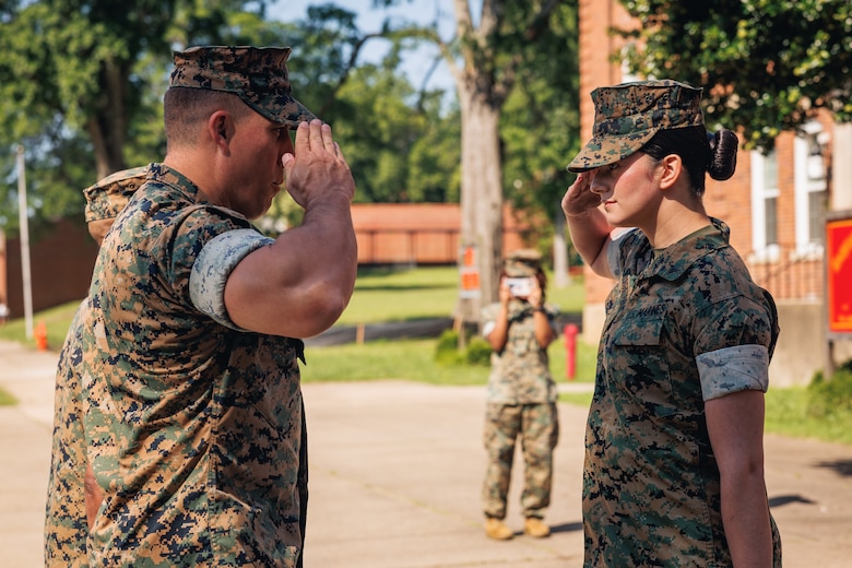U.S. Marine Corps Lance Cpl. Abigail Rodriguezpabon, a Florida native and an administrative specialist with Security Battalion, right, salutes Lt. Col. Gerard VanderWaal, commanding officer of Security Battalion, before receiving an impact Navy and Marine Corps Achievement Medal on Marine Corps Base Quantico, Virginia, June 20, 2025. On 8 May, Rodriguezpabon performed lifesaving actions at the scene of a serious motor vehicle accident involving several vehicles on the southbound road of Jefferson Davis Highway—Route 1; she applied training techniques she learned years ago from Marine Corps recruit training and Marine Combat Training, effectively applying a tourniquet to one of the casualties with an injured leg and bringing him to consciousness with a sternum rub. “You don’t have to be whatever military occupational specialty to save a life or even make a difference—anyone can make a difference,” she said. (U.S. Marine Corps photo by Lance Cpl. Braydon Rogers)