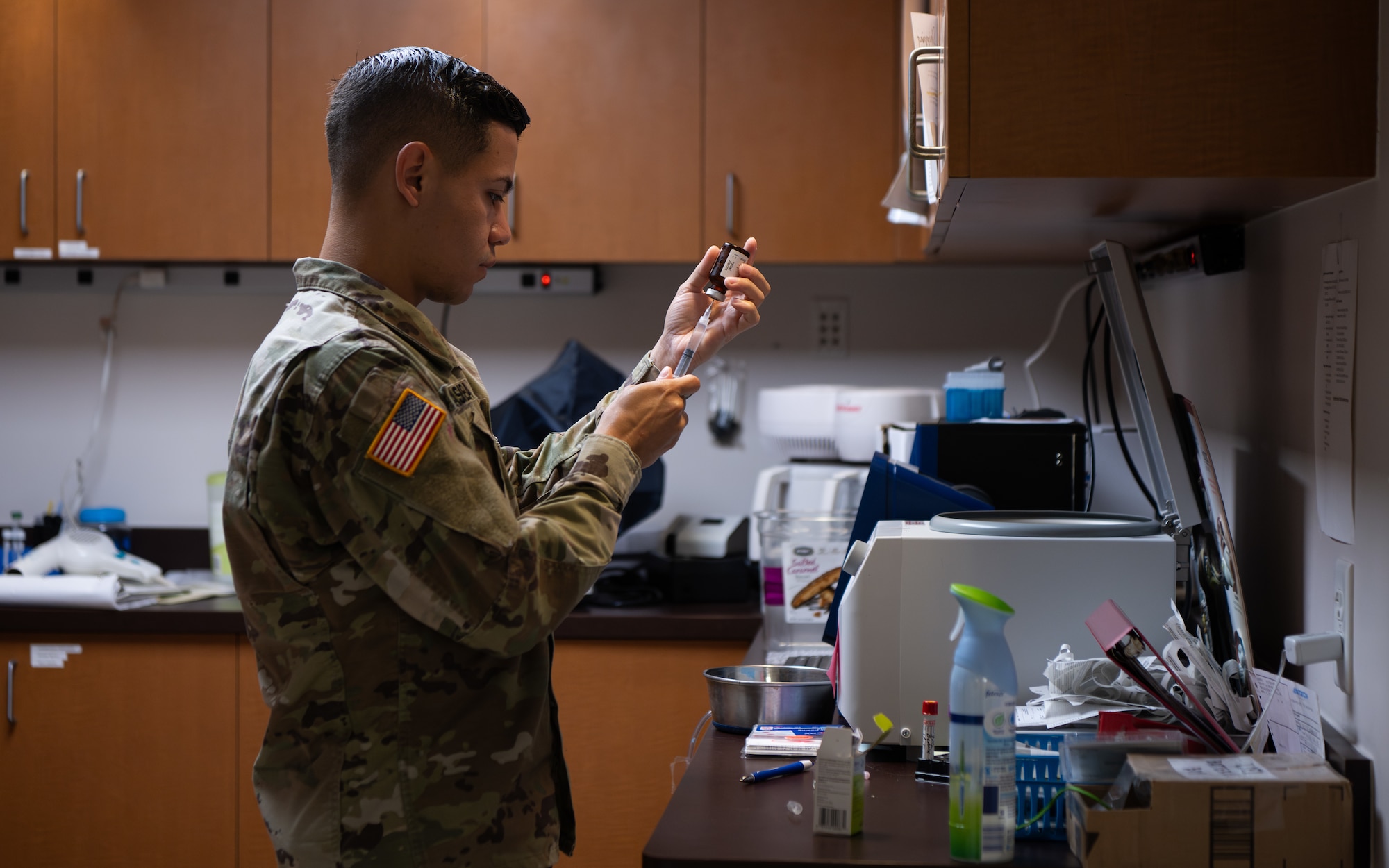 U.S. Army Corporal Vargas Medina, an animal care specialist assigned to the Veterinarian Readiness Activity, Patrick Space Force Base, Florida, prepares to do an annual dental checkup on a U.S. Air Force military working dog assigned to the 6th Security Forces Squadron at MacDill Air Force Base, Florida, June 3, 2025. The 6th SFS teams up with Army veterinarians to ensure military working dogs stay mission ready at all times. (U.S. Air Force photo by Airman 1st Class Helen Ly)
