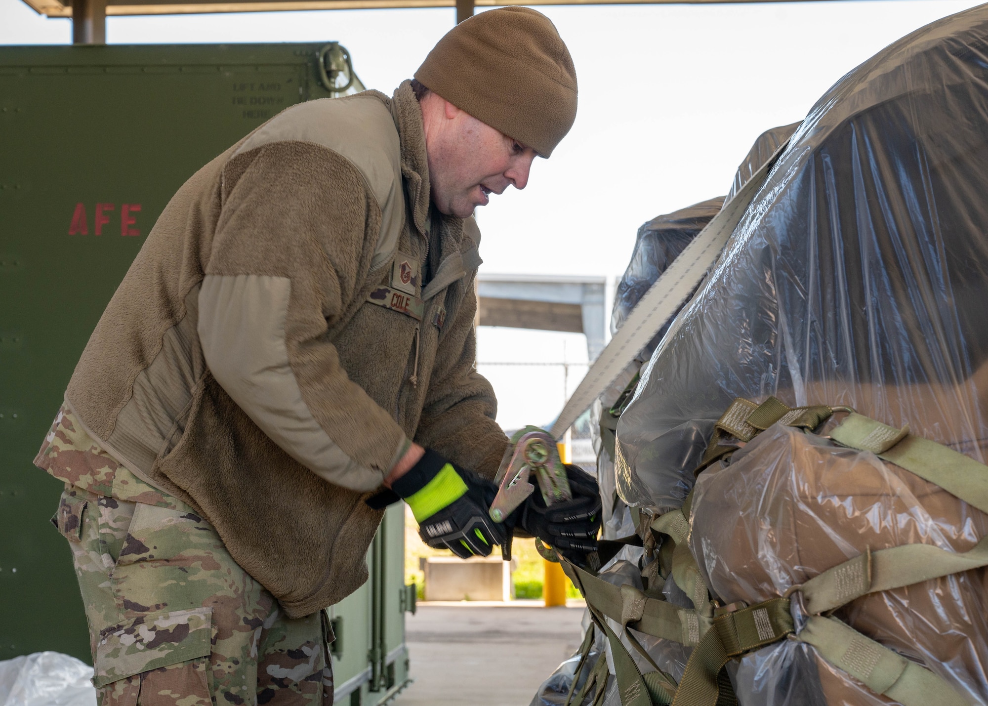 Photo of personnel strapping down a pallet.