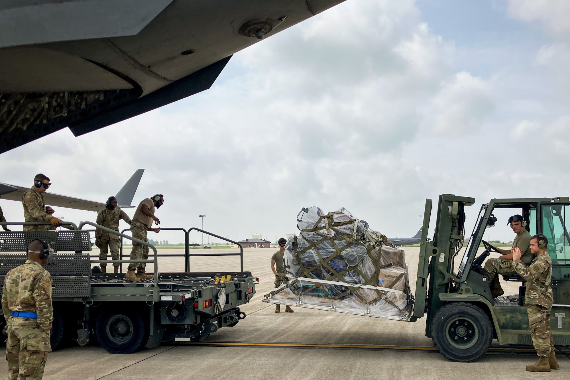 Airmen from the 49th Aerial Port Squadron load humanitarian aid onto a C-17 Globemaster III assigned to the 437th Air Wing while at Grissom Air Reserve Base, Ind., Jun. 6, 2025. The Airmen built and loaded cargo pallets holding over 8,000 pounds of humanitarian cargo in support of the Denton Humanitarian Assistance program, providing aid to those in need and hands-on training for expeditionary support. (Courtesy photo.)