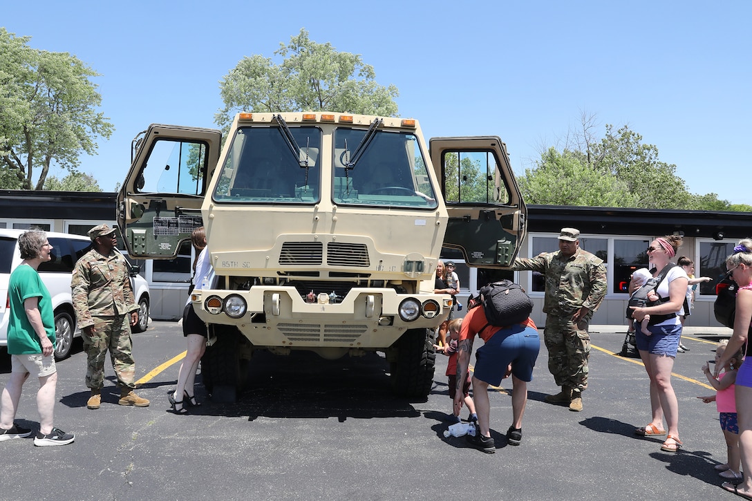 Event attendees gather to climb into a U. S Army truck during the annual Rolling Meadows Touch a Truck event, June 20, 2025.