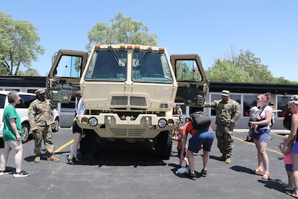 Event attendees gather to climb into a U. S Army truck during the annual Rolling Meadows Touch a Truck event, June 20, 2025.