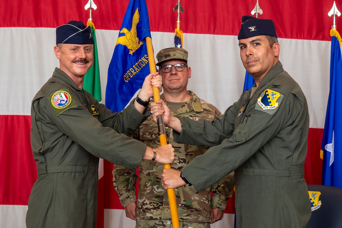 Two men hold a flag