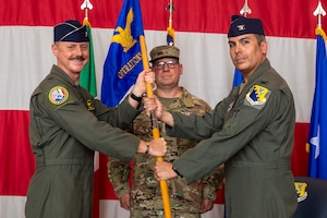 Two men hold a flag