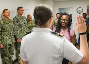 060625-N-FB730-1001 CAMP LEJEUNE (June 6, 2025) Dr. Andrea Karsten (right) commissions as a Navy psychiatric officer in the out-patient mental health conference room of naval Medical Center Camp Lejeune on June 6, 2025. The Combined Military-Civilian Psychiatry Residency Program is a partnership between NMCCL and NOVANT Health that puts medical residents through four years of clinical training in psychiatry.