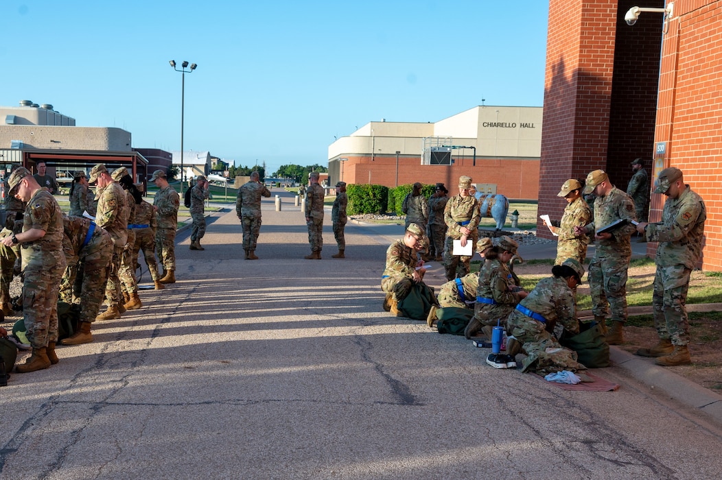 Members of the 315th Training Squadron stand outside of their campus as they participate in an inspection as part of a mock deployment held at Goodfellow Air Force Base, Texas, June 25th. This event represents a broader effort by the 315th to make operational preparedness a routine part of the students’ experience. (U.S. Air Force photo by Airman 1st Class James Salellas)