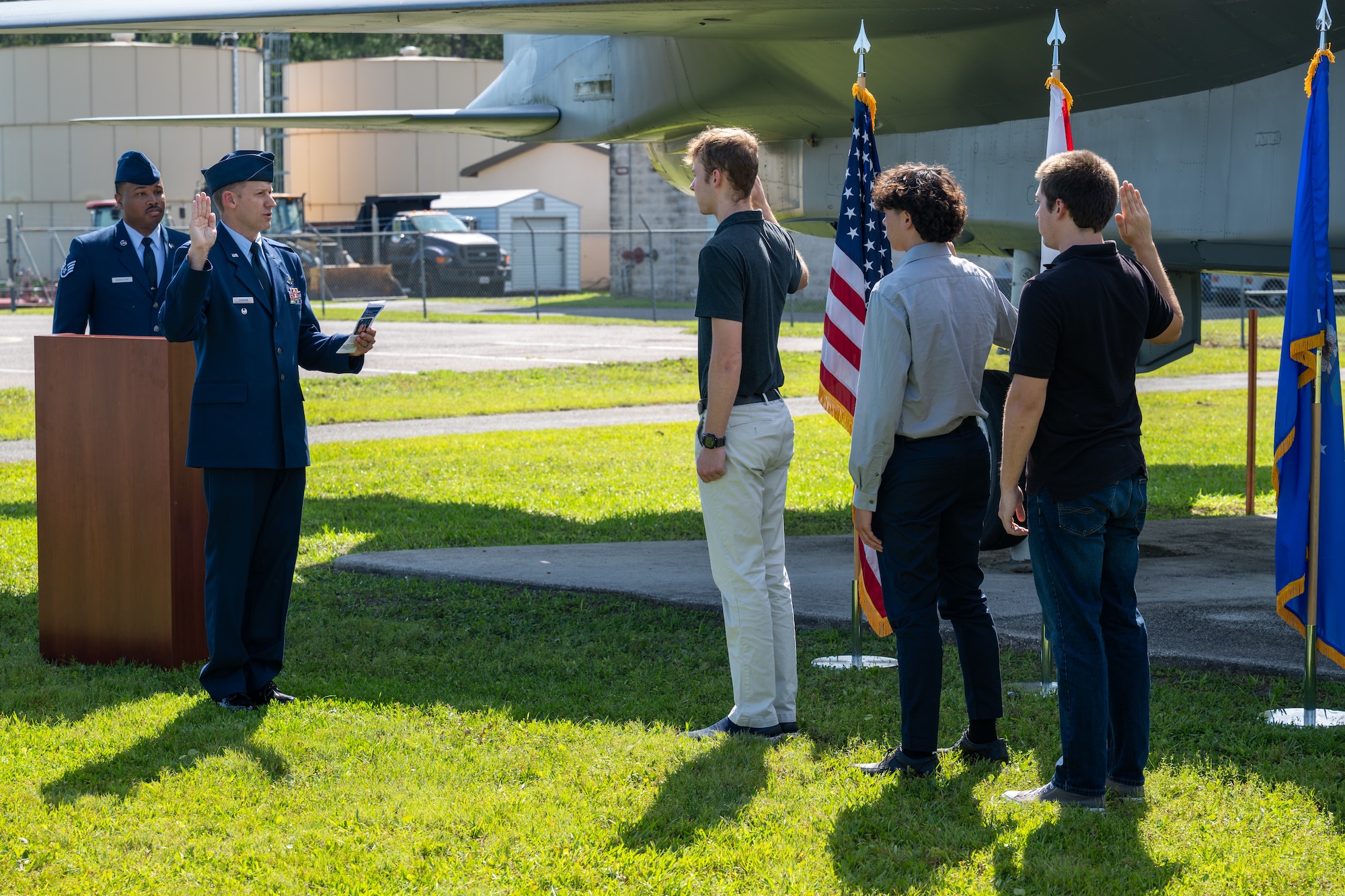 Photo of commander administering oath of enlistment to new recruits.