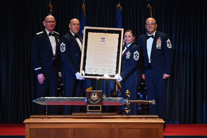 Gen. Duke Z. Richardson, commander, Air Force Materiel Command, poses with Chief Master Sgt. Jalil Samavarchian, Chief Master Sgt. Tessa M. Fontaine, and Chief Master Sgt. Bill Fitch following the presentation of the Order of the Sword proclamation.