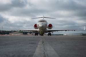 A white plane sitting on the airfield.