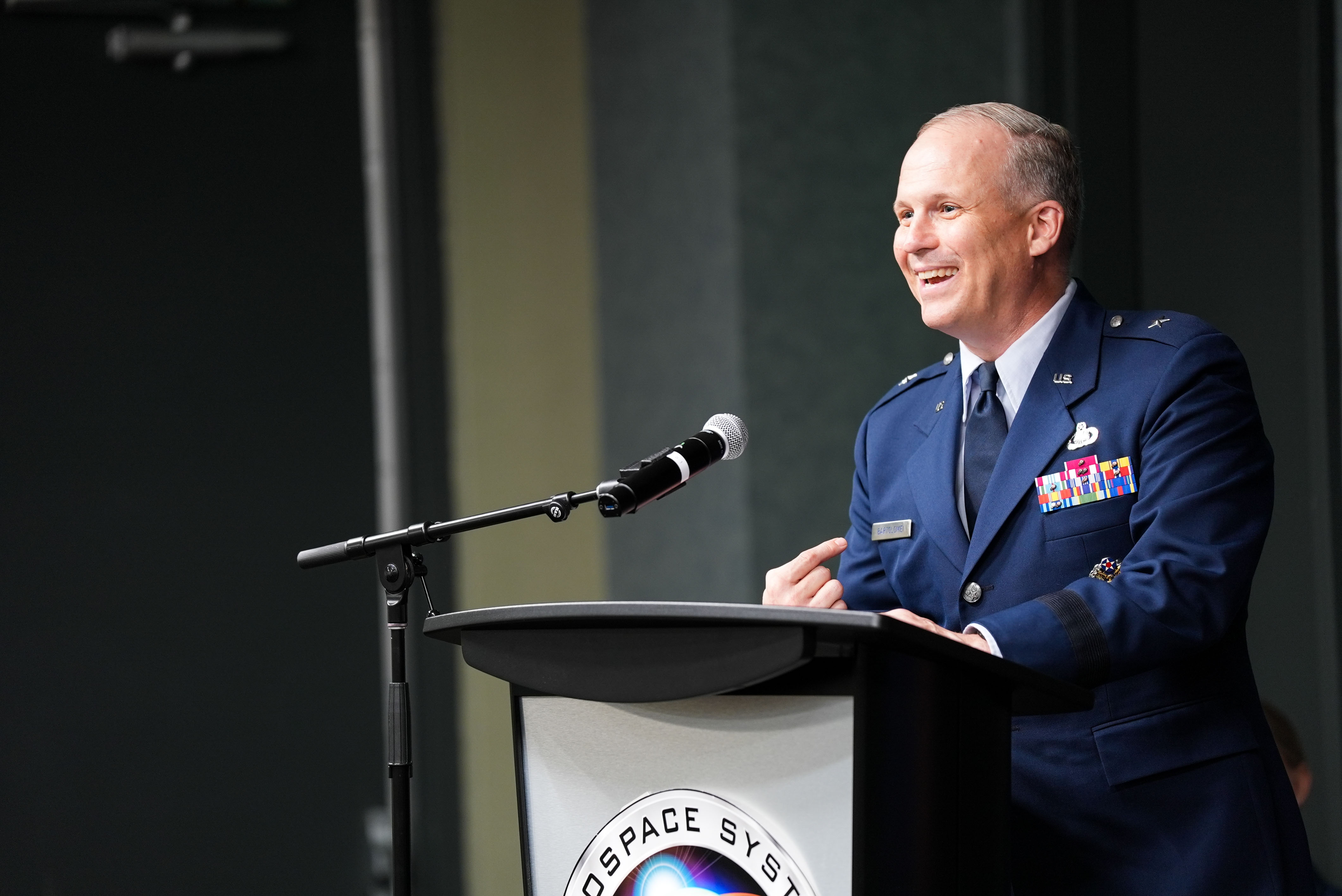 Brig. Gen. Jason Bartolomei, Commander of the Air Force Research Laboratory (AFRL), speaks at the AFRL Change of Responsibility Ceremony at Wright-Patterson Air Force Base, Ohio, June 18, 2025.  The incoming command chief is Chief Master Sgt. Timothey Hodgin and the outgoing command chief is Chief Master Sgt. Carlos Labrador. (U.S. Air Force photo by Ryan Law)