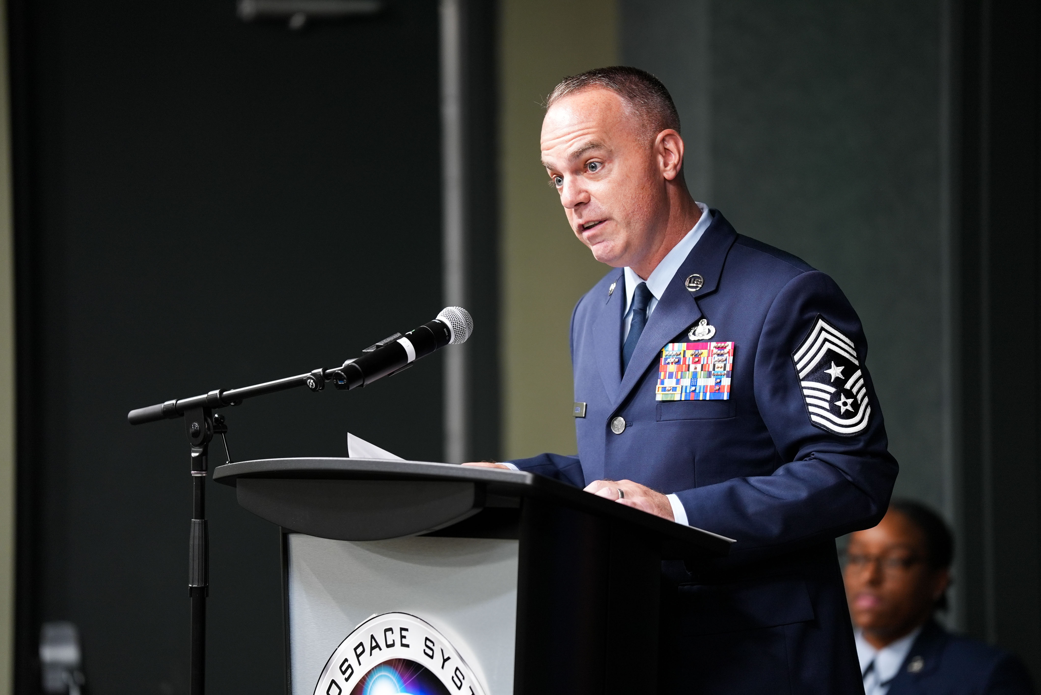 Chief Master Sgt. Timothey Hodgin, incoming command chief of the Air Force Research Laboratory (AFRL), speaks at the AFRL Change of Responsibility Ceremony at Wright-Patterson Air Force Base, Ohio, June 18, 2025.  The outgoing command chief is Chief Master Sgt. Carlos Labrador. (U.S. Air Force photo by Ryan Law)