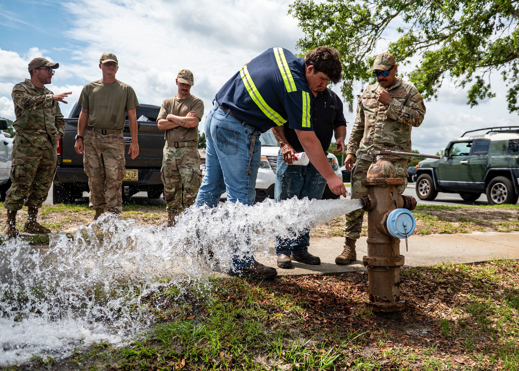 U.S Air Force Airmen assigned to the 23rd Civil Engineer Squadron and Lowndes County contractors take a water sample at Moody Air Force Base, Georgia, May 28, 2025. This proactive testing highlighted the partnership between Moody AFB and Lowndes County in maintaining safe water standards. (U.S. Air Force photo by Senior Airman Leonid Soubbotine)