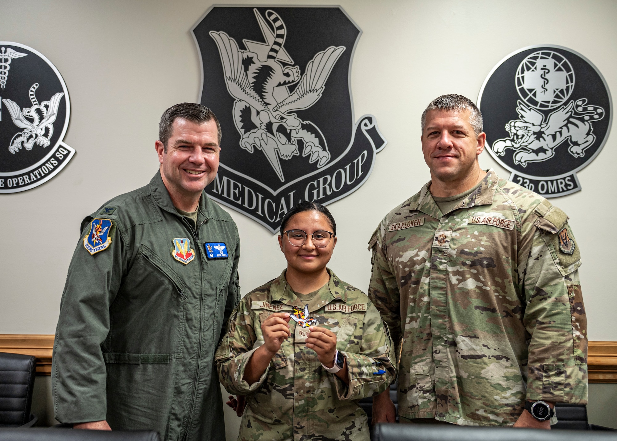 U.S. Air Force Col. Paul Sheets, 23rd Wing commander, left, and Chief Master Sgt. Joshua Skarloken, 23rd Wing command chief, right, recognize Senior Airman Janet Jimenez, 23rd Operational Medical Readiness Squadron bioenvironmental engineering technician, middle, at Moody Air Force Base, Georgia, June 17, 2024. Jimenez played a crucial role safeguarding the base during the water issue at Moody. (U.S. Air Force photo by Senior Airman Leonid Soubbotine)