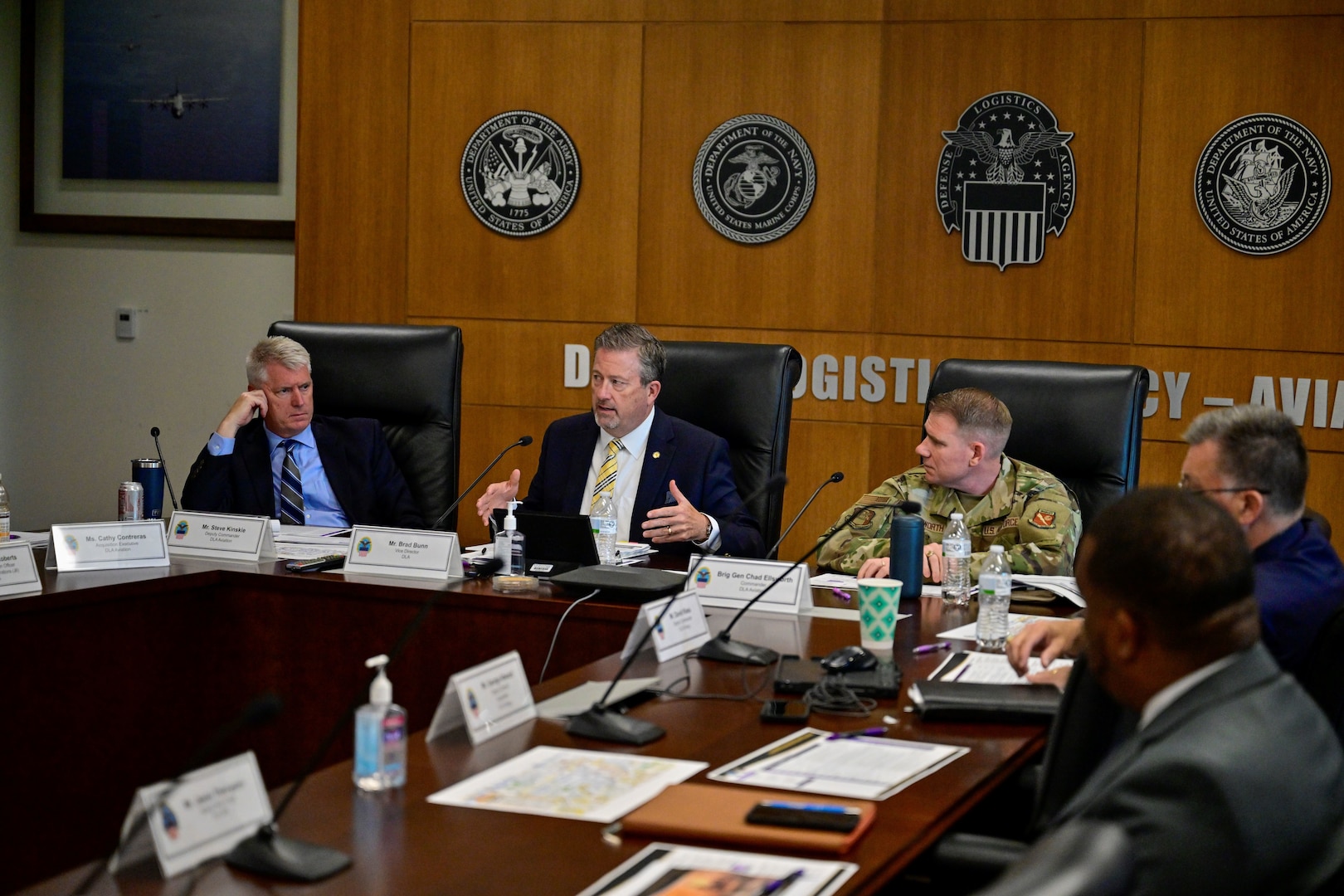 Senior leaders at table talking.