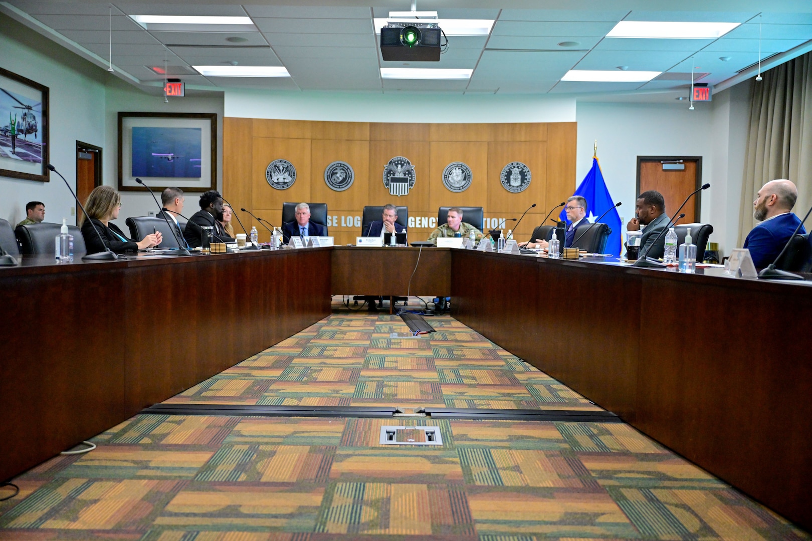 Senior Leaders around table in discussion.