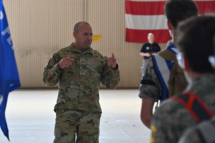 Two Airmen Saluting new commander