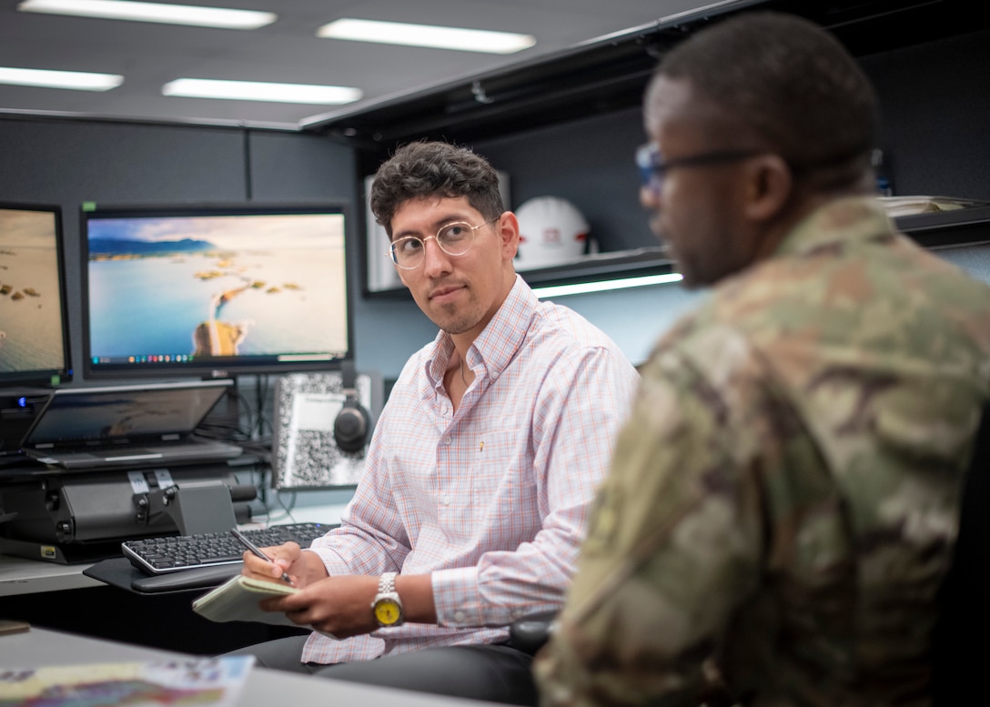 Department of Army intern Juan Gonzalez meets with Maj. Terence Ngoh, the officer-in-charge of the Military Contracting Branch at U.S. Army Corps of Engineers' Fort Worth District, May 28, 2025, in Fort Worth, Texas. (US Army photo by Richard Bumgardner, SWF Public Affairs)