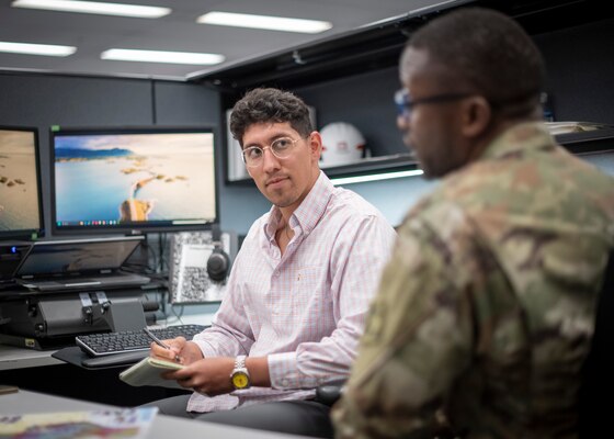 Department of Army intern Juan Gonzalez meets with Maj. Terence Ngoh, the officer-in-charge of the Military Contracting Branch at U.S. Army Corps of Engineers' Fort Worth District, May 28, 2025, in Fort Worth, Texas. (US Army photo by Richard Bumgardner, SWF Public Affairs)