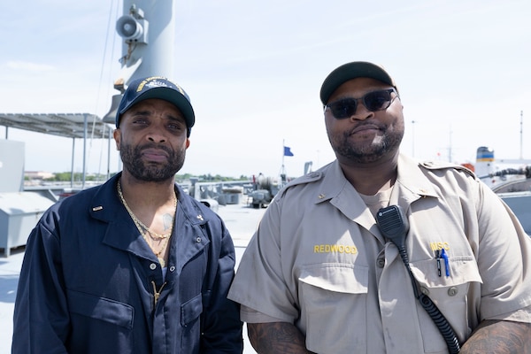 Military Sealift Command (MSC) Civil Service Mariners (CIVMARs), 3rd Assistant Engineer Greg Saddler and Cargo Mate Joseph Redwood, pose for a photo aboard the fleet replenishment oiler USNS Joshua Humphreys (T-AO 188). The two best friends have sailed with MSC for nearly 20 years and worked their way up the ranks from entry-level CIVMARs to licensed merchant mariners.