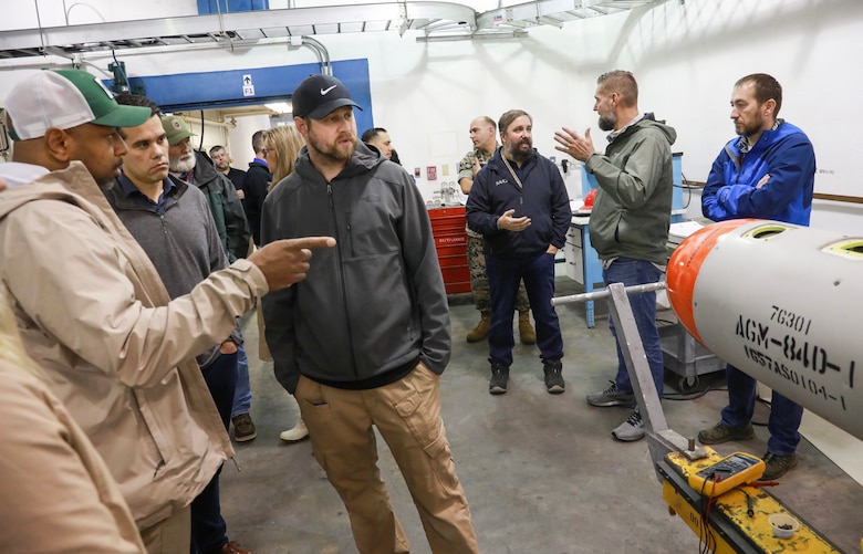 Ammo Product Manager John Swain (l) and Dept. of Defense Explosives Safety Board Jose Rullan-Rodriguez question Electronic Tech Michael Jenkins about the process of receiving missiles and converting them into Airbirds at NWS Yorktown, Virginia, May 22, 2025.
