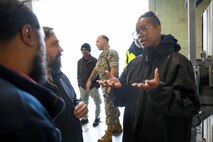NWS Yorktown work leader Team 2 Latronda Curry, explains how the weapons are marked and stored in the magazine to Ammo Product Manager Melvin Miller and Christian Zwileneff, May 22, 2025.