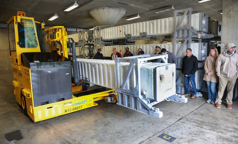 A Combilift, multi-directional forklift, demonstrates how efficiently it can maneuver through tight aisles as it carries a slip containing a Tomahawk missile during the training opportunity at NWS Yorktown, Virginia, May 22, 2025.