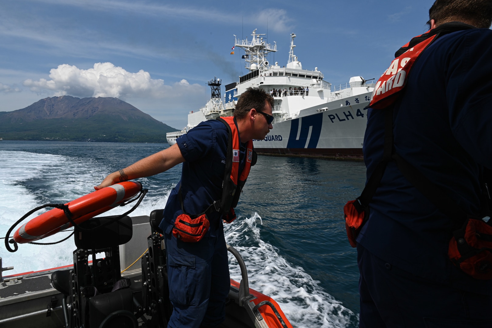 Legend-class U.S. Coast Guard Cutter Stratton (WMSL 752) crewmember, Petty Officer 3rd Class Matthew Woodall, a boatswain’s mate, throws a life ring to recover an oscar mannequin from the water during a trilateral search and rescue exercise with the U.S., Japan and Philippine Coast Guards in Kagoshima, Japan, June 20, 2025. Stratton is deployed and assigned to Destroyer Squadron (DESRON) 15, the Navy’s largest DESRON and the U.S. 7th Fleet’s principal surface force. Stratton is deployed to the Indo-Pacific to advance relationships with ally and partner nations to build a more secure and prosperous region with unrestricted, lawful access to the maritime commons. (U.S. Coast Guard photo by Petty Officer 2nd Class Kate Kilroy)