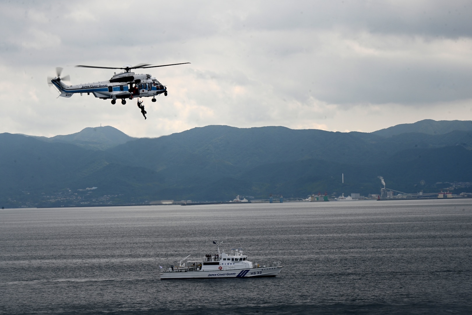 A Japan Coast Guard helicopter lowers a rescue diver during a trilateral search and rescue exercise with the U.S. Coast Guard Cutter Stratton (WMSL 752) and the Philippine Coast Guard vessel BRP Teresa Magbanua (MRRV-9701) in Kagoshima, Japan, June 2025. Stratton is deployed and assigned to Destroyer Squadron (DESRON) 15, the Navy’s largest DESRON and the U.S. 7th Fleet’s principal surface force. Stratton is deployed to the Indo-Pacific to advance relationships with ally and partner nations to build a more secure and prosperous region with unrestricted, lawful access to the maritime commons. (U.S. Coast Guard photo by Senior Chief Petty Officer Matthew S. Masaschi)
