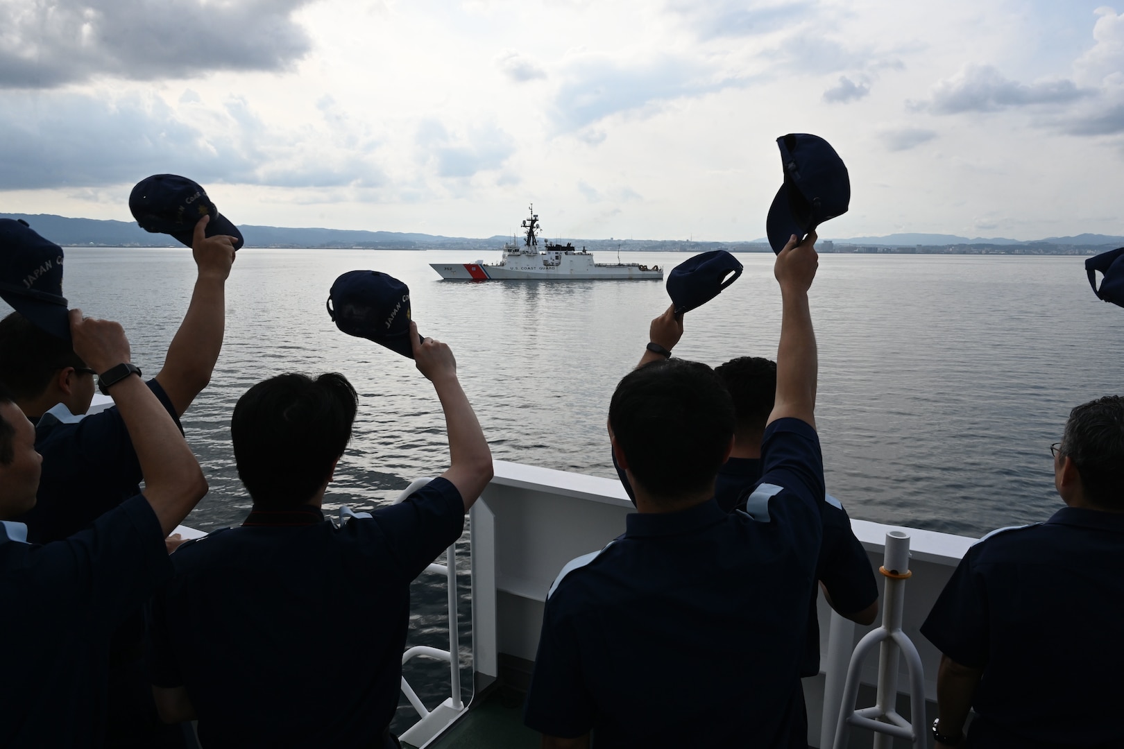 Japan Coast Guard members aboard the Japan Coast Guard Patrol Vessel Asanagi (PLH-43) wave to the Legend-class U.S. Coast Guard Cutter Stratton (WMSL 752) following a trilateral search and rescue exercise with U.S., Japan and Philippine Coast Guards in Kagoshima, June 20, 2025. Stratton is deployed and assigned to Destroyer Squadron (DESRON) 15, the Navy’s largest DESRON and the U.S. 7th Fleet’s principal surface force. Stratton is deployed to the Indo-Pacific to advance relationships with ally and partner nations to build a more secure and prosperous region with unrestricted, lawful access to the maritime commons. (U.S. Coast Guard photo by Senior Chief Petty Officer Matthew S. Masaschi)