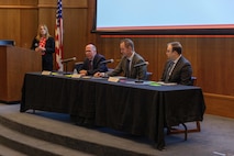 Acquisition professionals observe presentations from industry partners at the Reverse Industry Day.