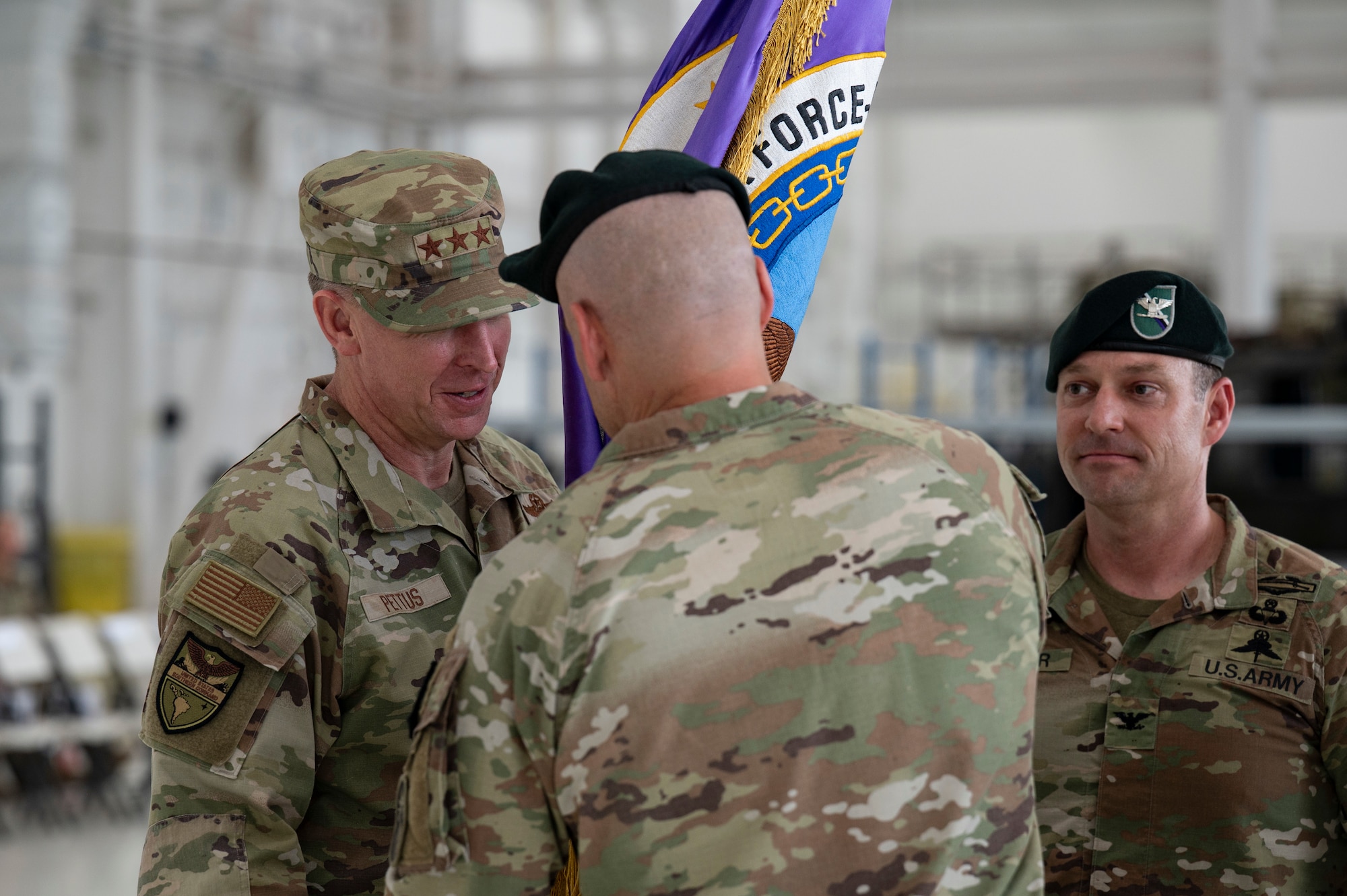 Lt. Gen. Pettus retrieves the JTF-Bravo command flag from the outgoing commander Col. Daniel Alder during the JTF-Bravo change of command ceremony