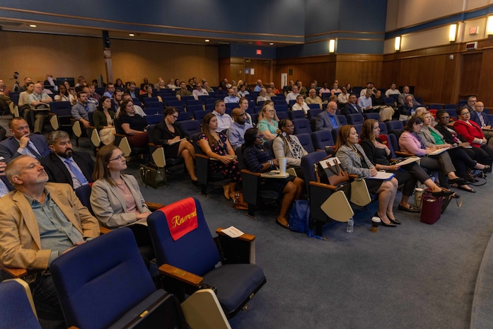 Acquisition professionals observe presentations from industry partners at the Reverse Industry Day.