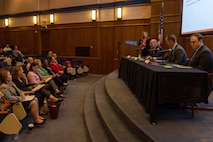 Acquisition professionals observe presentations from industry partners at the Reverse Industry Day.