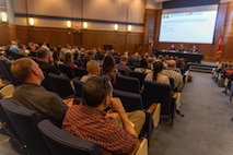 Acquisition professionals observe presentations from industry partners at the Reverse Industry Day.