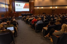Acquisition professionals observe presentations from industry partners at the Reverse Industry Day.