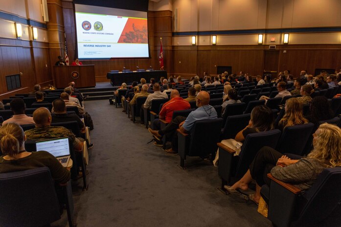 Acquisition professionals observe presentations from industry partners at the Reverse Industry Day.
