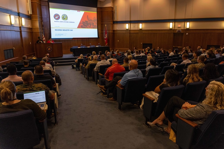 Acquisition professionals observe presentations from industry partners at the Reverse Industry Day.