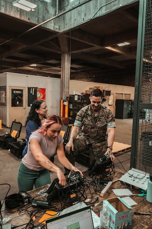U.S. Marines and civilian personnel receive and inspect the Handheld Radio Test Set (HHRTS) during fielding with II Marine Expeditionary Force at Marine Corps Base Camp Lejeune, N.C., on May 21, 2025.