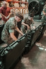 U.S. Marines and civilian personnel receive and inspect the Handheld Radio Test Set (HHRTS) during fielding with II Marine Expeditionary Force at Marine Corps Base Camp Lejeune, N.C., on May 21, 2025.