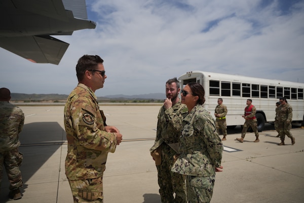 Master Sgt. Justin Staten, aerospace medical service craftsman, assigned to Wright-Patterson Air Force Base, discusses aeromedical evacuation to Hospital Corpsman 2nd Class Taylor Plantikow and Hospital Corpsman 2nd Class Zachary Miller, staff instructors at Naval Expeditionary Medicine Warfighter Development Center (NEMWDC) May 12, 2025. As subject matter experts in En-Route Care System (ERCS), Plantikow and Miller support the development and execution of high-fidelity medical scenarios that prepare teams for real-world operations. This integrated training brought together Navy and Air Force medical personnel to practice enhancing interoperability and improving casualty evacuation readiness across services. (U.S. Navy photo by Petty Officer 2nd Class Moira Esquivel)