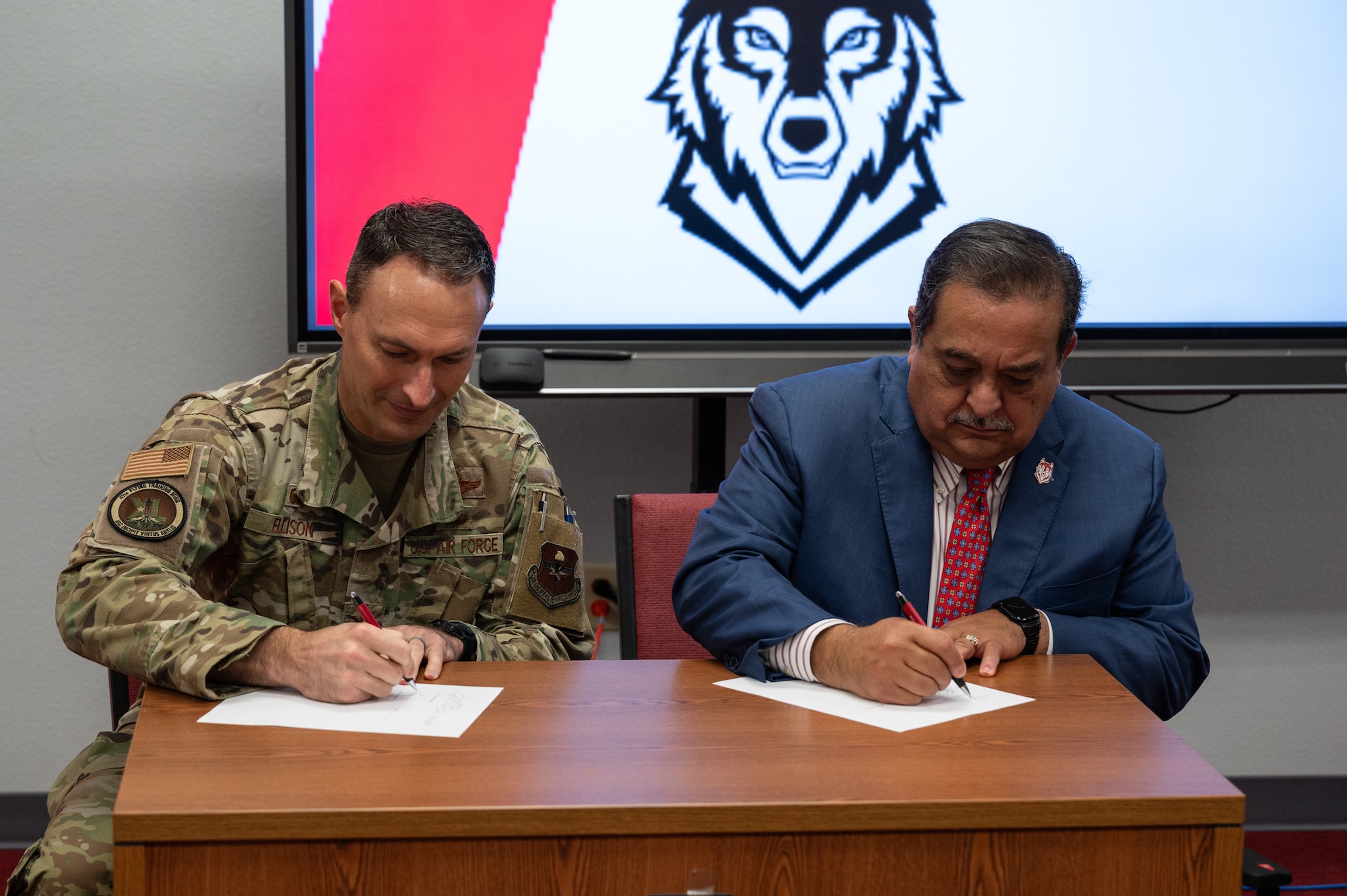 U.S. Air Force Col. Tyler Ellison, 47th Flying Training Wing commander, and Sul Ross State University President Carlos Hernandez sign a memorandum of understanding during a partnership event at Sul Ross State University in Del Rio, Texas, June 25, 2025. The agreement expands opportunities for Airmen to pursue higher education and professional development. (U.S. Air Force photo by Joseph Pagan)