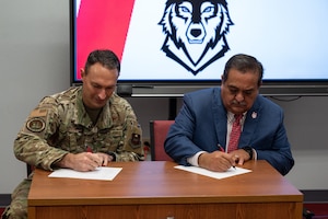 U.S. Air Force Col. Tyler Ellison, 47th Flying Training Wing commander, and Sul Ross State University President Carlos Hernandez sign a memorandum of understanding during a partnership event at Sul Ross State University in Del Rio, Texas, June 25, 2025. The agreement expands opportunities for Airmen to pursue higher education and professional development. (U.S. Air Force photo by Joseph Pagan)