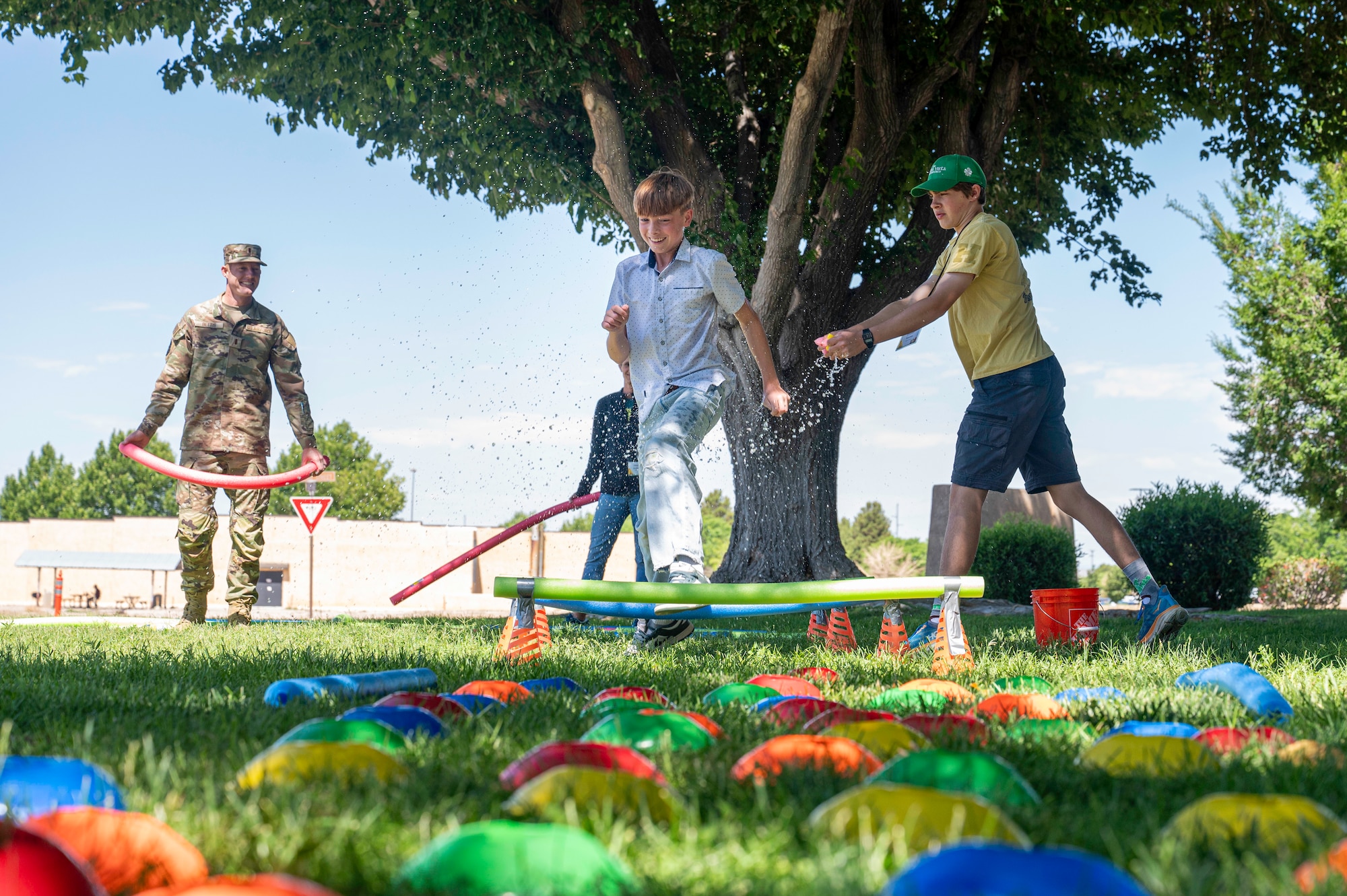 A child jumps over an obstacle