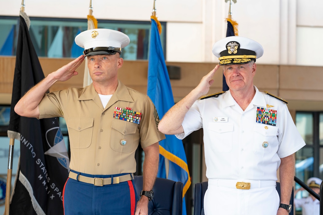 Adm. Samuel J. Paparo, commander of U.S. Indo-Pacific Command, and U.S. Marine Corps Sgt. Maj. Eric Cook, USINDOPACOM senior enlisted leader, salute the national anthem during Cook's Assumption of Responsibility Ceremony at USINDOPACOM headquarters on Camp H.M. Smith, in Honolulu, June 26, 2025.