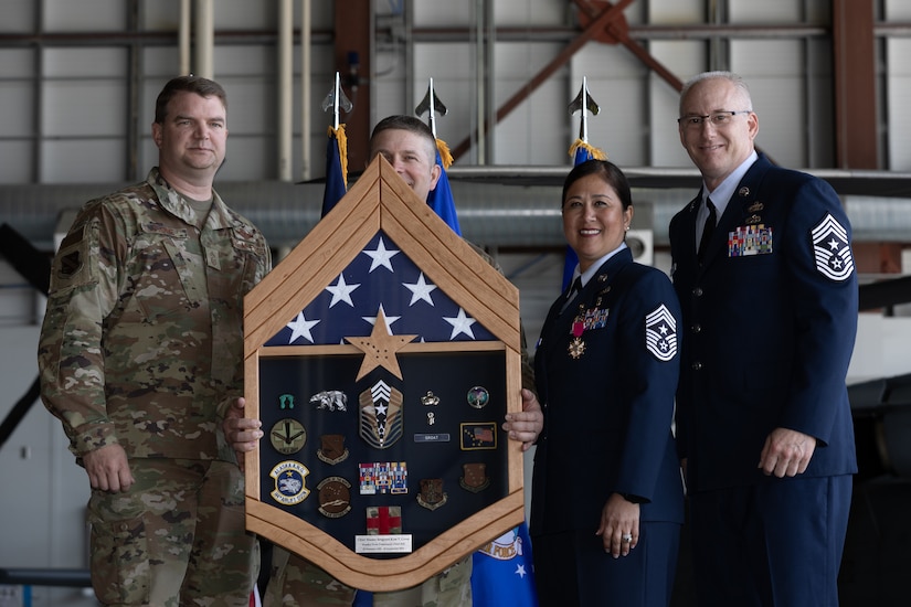 Chief Master Sgt. Kim T. Groat relinquishes the position of the State Command Chief Master Sergeant of the Alaska Air National Guard to Chief Master Sgt. Jeffrey A. Ling during a change of responsibility ceremony at Joint Base Elmendorf-Richardson, Alaska, June 18, 2025. Brig. Gen. Brian D. Kile, the commander of the Alaska Air National Guard, presided over the ceremony.